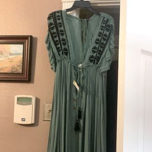 Long green dress with buttons down the front can be used for a cover or a dress